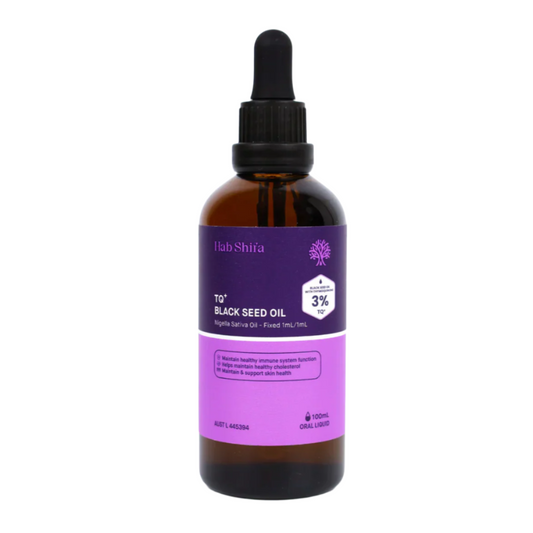 Bottle of black seed oil with a purple label on a white background